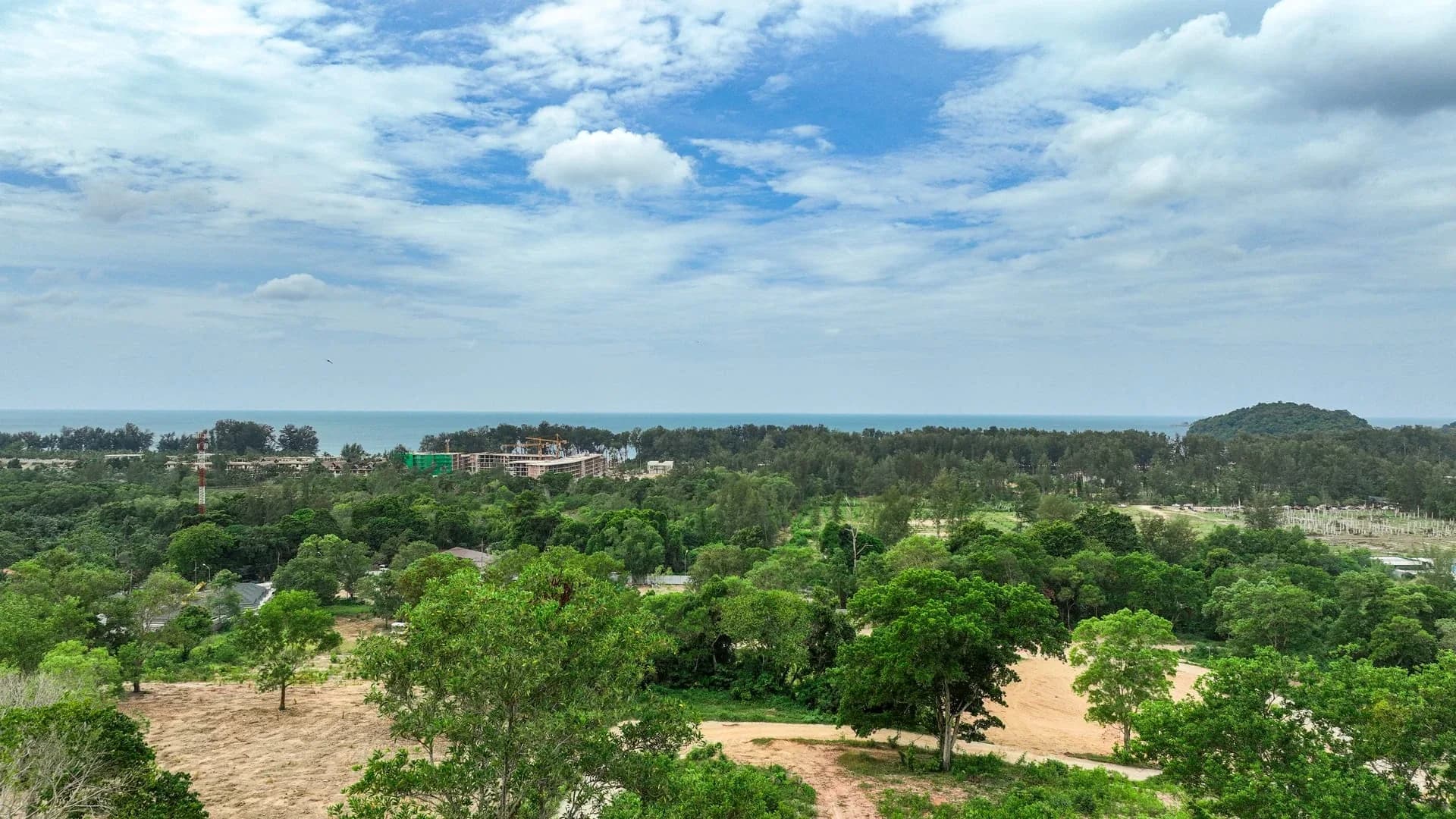 Sea-facing Layan Verde site context across the tropical hillside