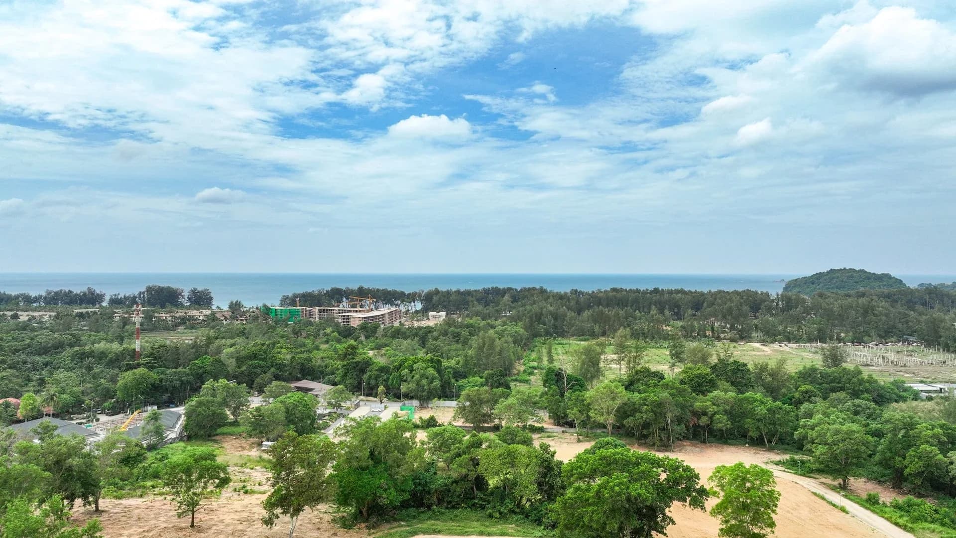 Wide site context from the hillside toward Bang Tao Bay